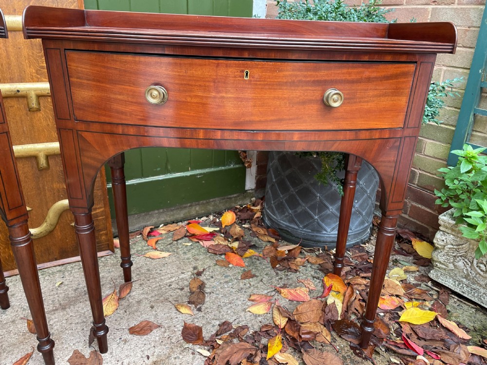 Pair of elegant early C19th late George III period mahogany bow-front side tables . View III