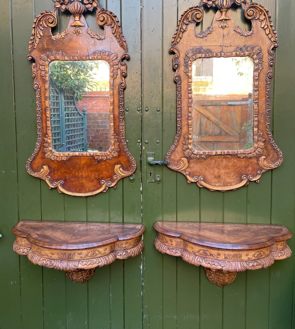 A pair of late nineteenth century carved walnut and parcel-gilt wall consoles with matching arch-top mirrors featuring urn and floral cresting. View VIII