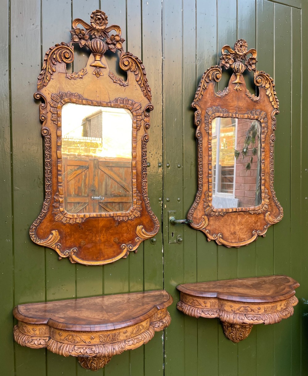 A pair of late nineteenth century carved walnut and parcel-gilt wall consoles with matching arch-top mirrors featuring urn and floral cresting. View XIV