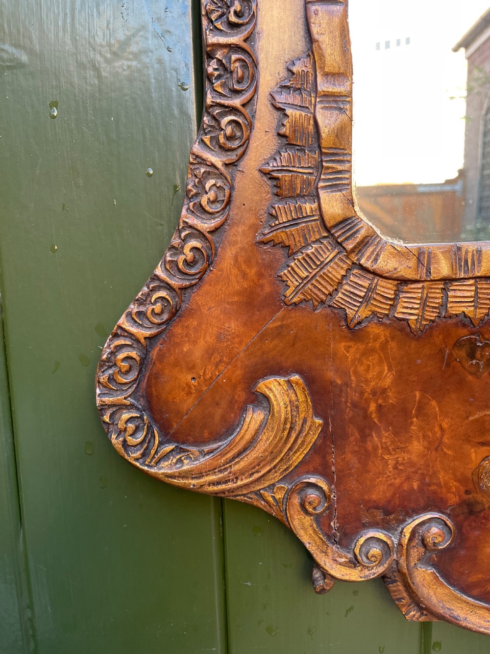 A pair of late nineteenth century carved walnut and parcel-gilt wall consoles with matching arch-top mirrors featuring urn and floral cresting. View XVII