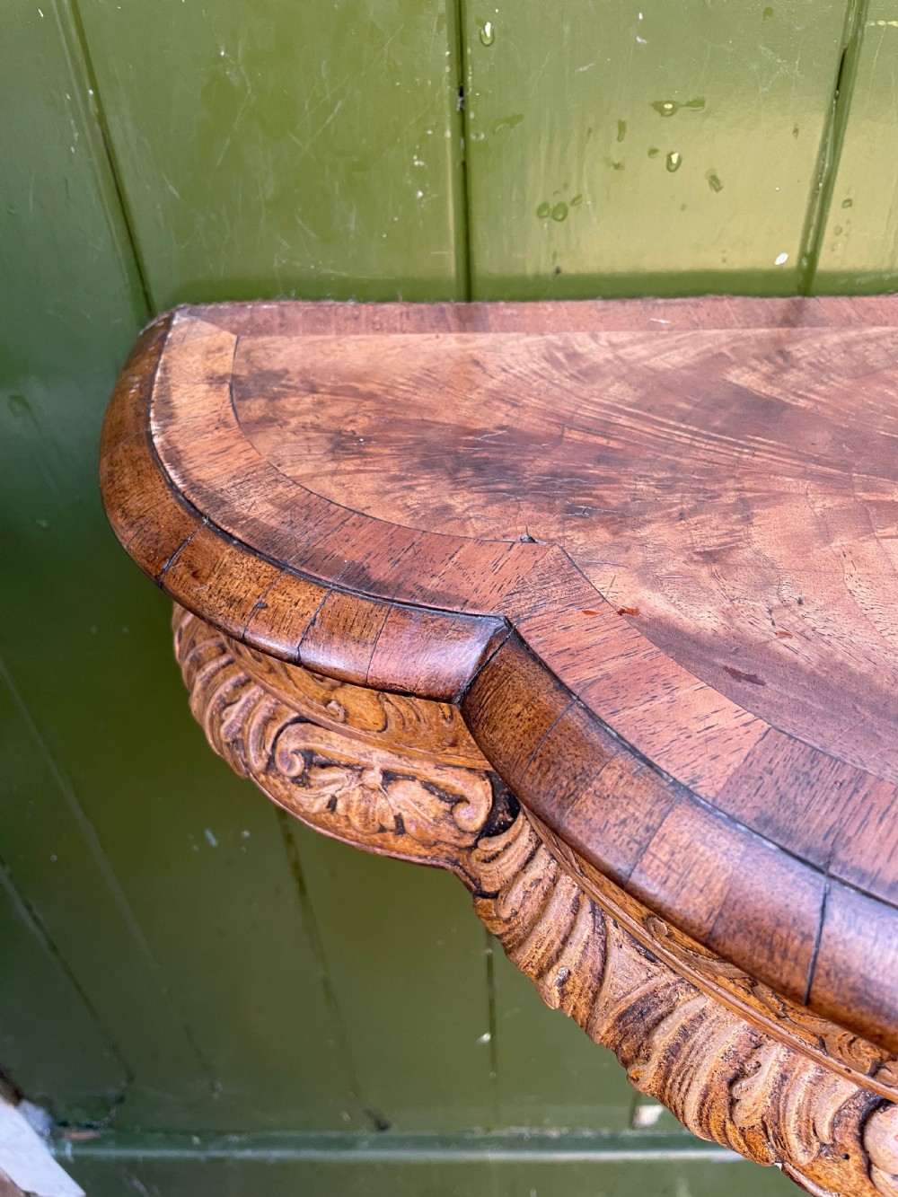 A pair of late nineteenth century carved walnut and parcel-gilt wall consoles with matching arch-top mirrors featuring urn and floral cresting. View XX