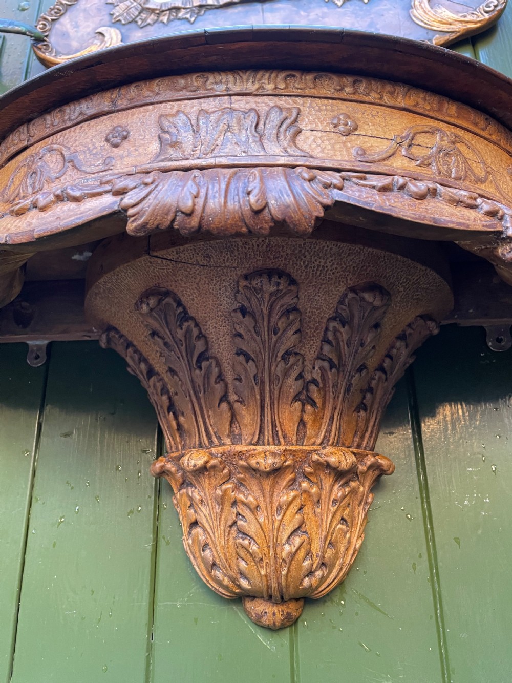 A pair of late nineteenth century carved walnut and parcel-gilt wall consoles with matching arch-top mirrors featuring urn and floral cresting. View XXI