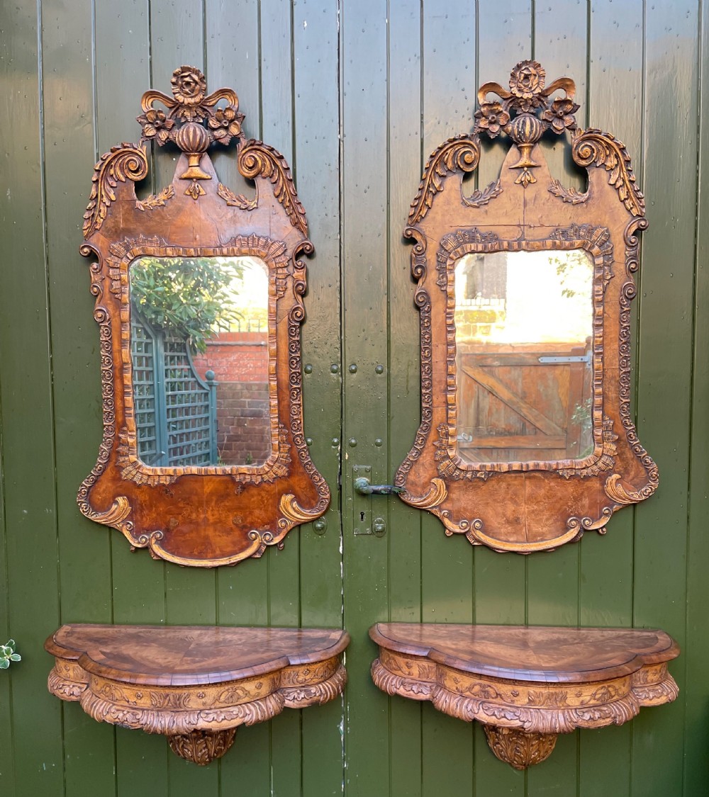 A pair of late nineteenth century carved walnut and parcel-gilt wall consoles with matching arch-top mirrors featuring urn and floral cresting. View XXVI