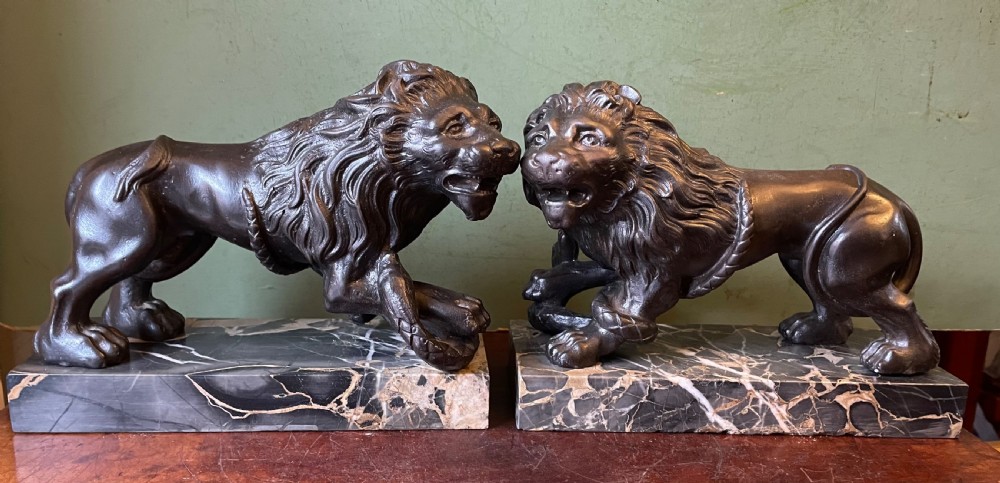 Pair of C19th French cast-iron lions with a bronze patination, mounted on portoro marble plinth bases . View II