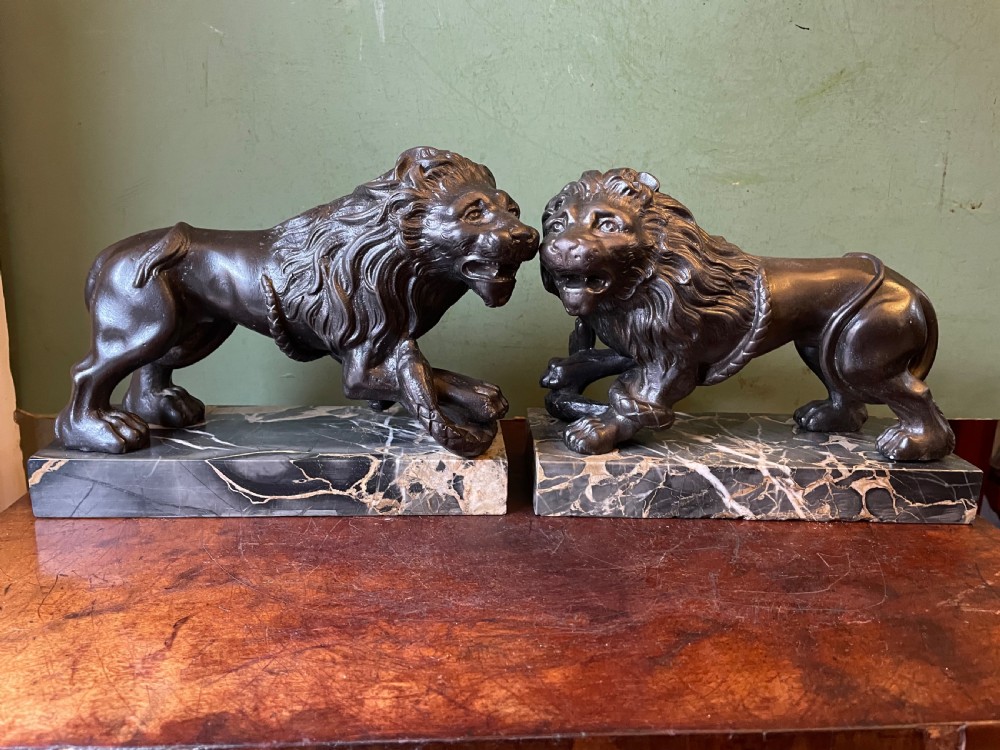 Pair of C19th French cast-iron lions with a bronze patination, mounted on portoro marble plinth bases . View IV