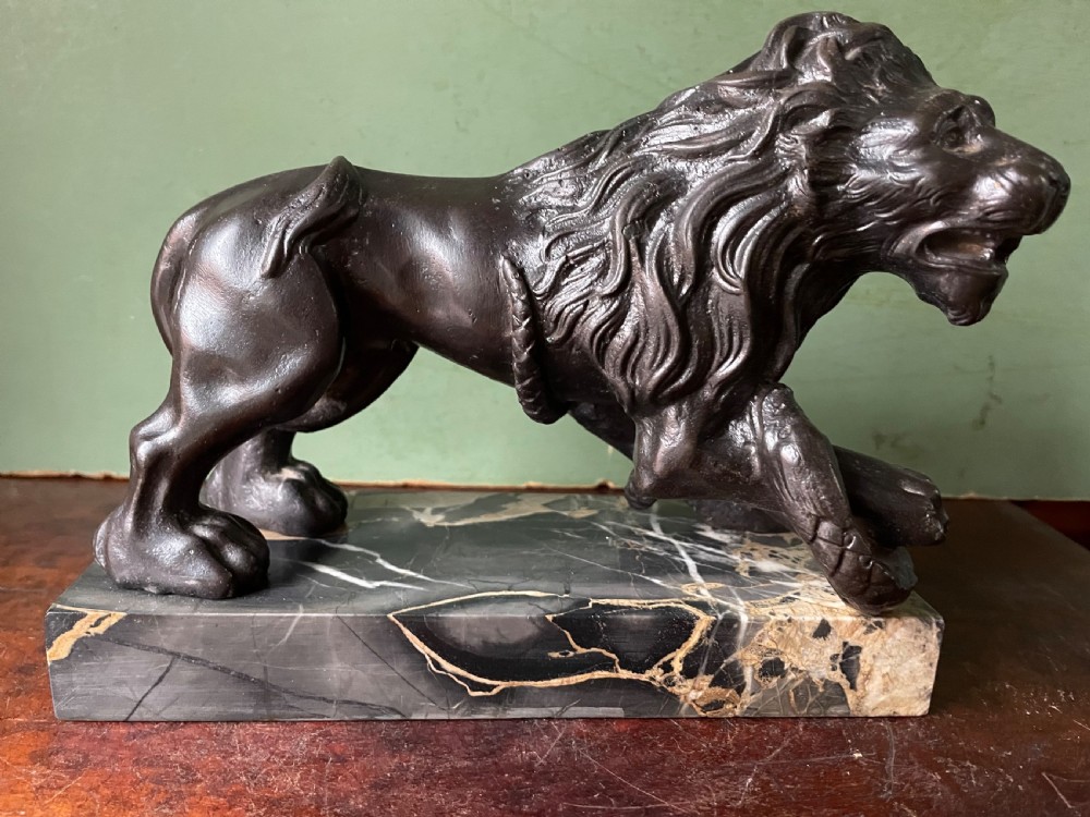 Pair of C19th French cast-iron lions with a bronze patination, mounted on portoro marble plinth bases . View IX