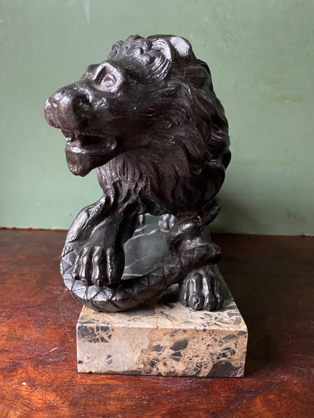 Pair of C19th French cast-iron lions with a bronze patination, mounted on portoro marble plinth bases . View XI
