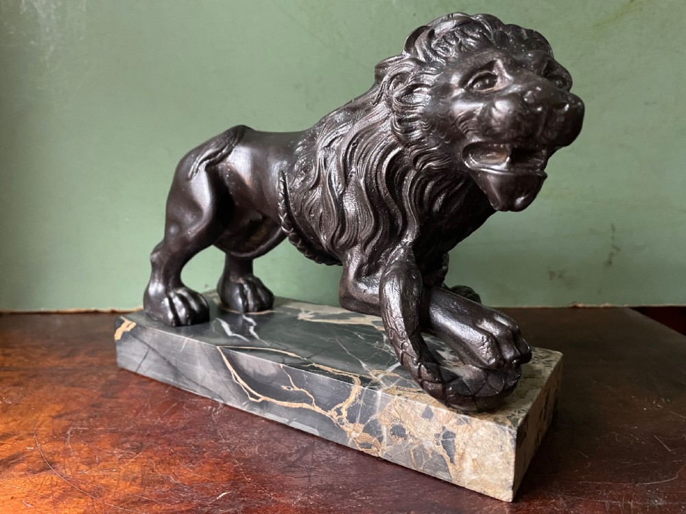Pair of C19th French cast-iron lions with a bronze patination, mounted on portoro marble plinth bases . View XII