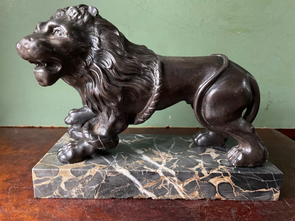 Pair of C19th French cast-iron lions with a bronze patination, mounted on portoro marble plinth bases . View XIII