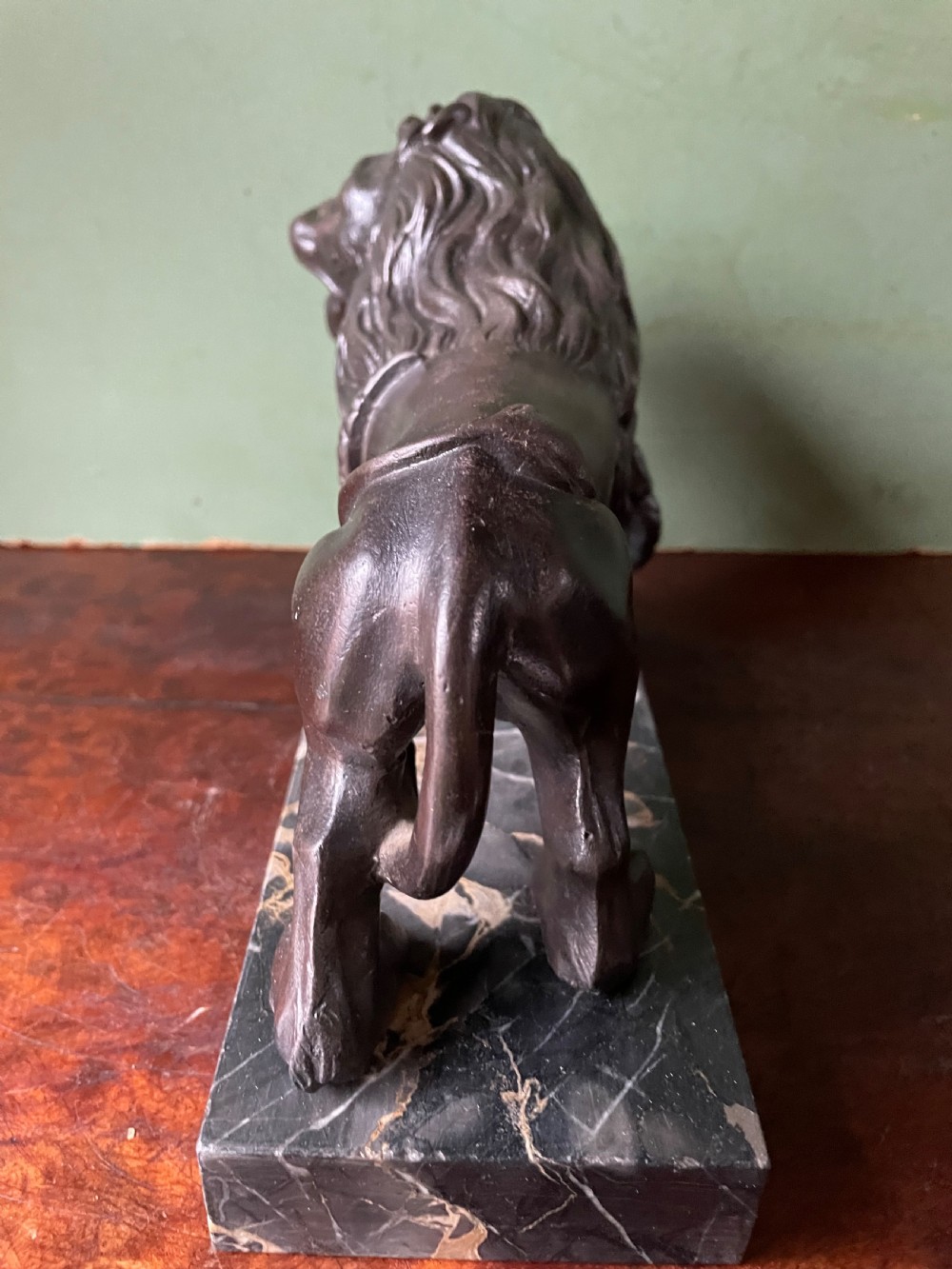 Pair of C19th French cast-iron lions with a bronze patination, mounted on portoro marble plinth bases . View XX