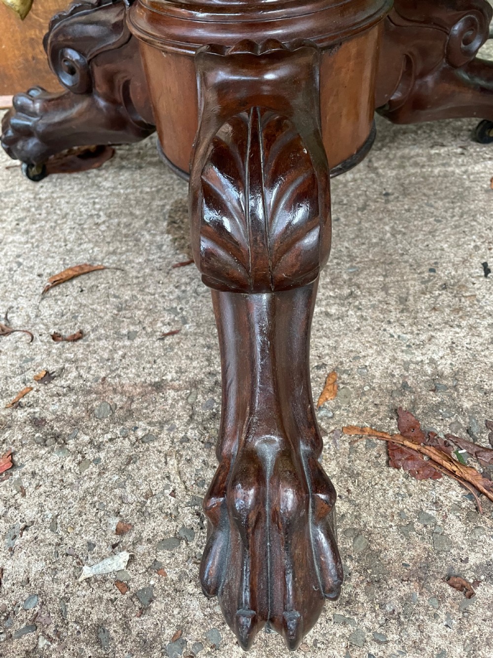 An early nineteenth-century French Charles X mahogany gueridon table featuring a circular grey marble top set upon a fluted pedestal stem and scrolled tripod feet. View IX