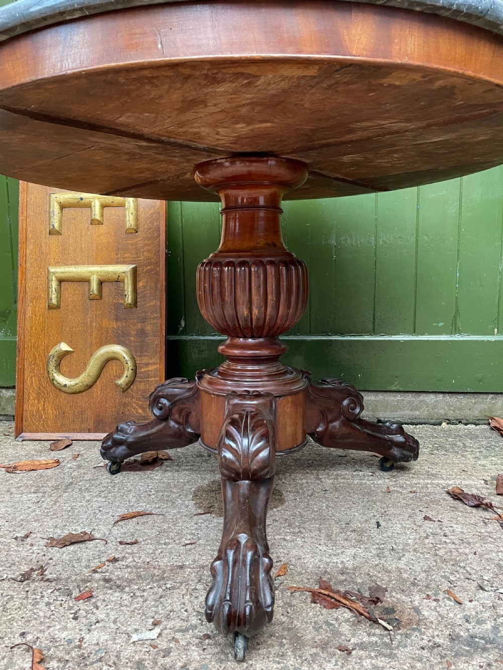 An early nineteenth-century French Charles X mahogany gueridon table featuring a circular grey marble top set upon a fluted pedestal stem and scrolled tripod feet. View XI