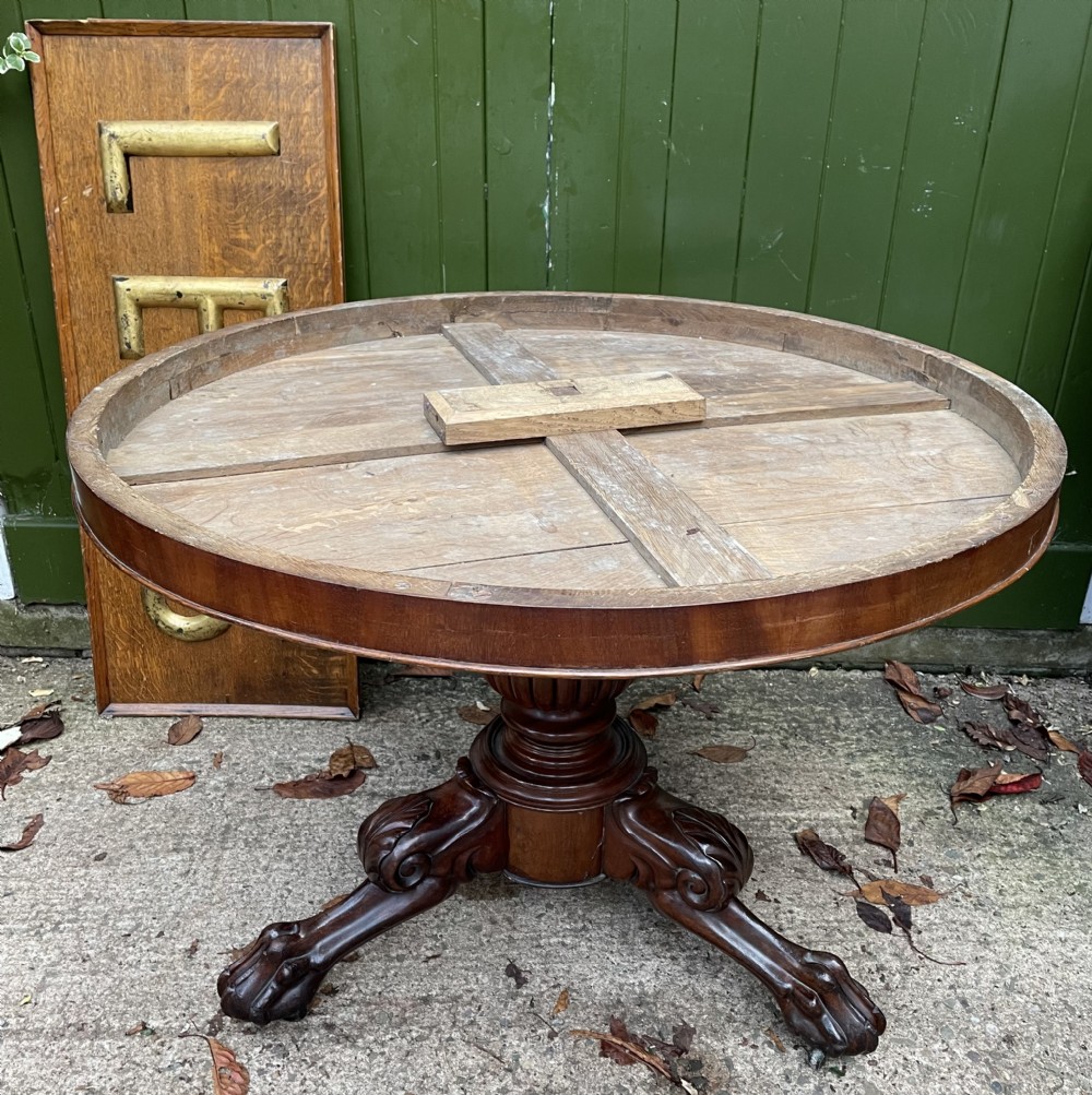 An early nineteenth-century French Charles X mahogany gueridon table featuring a circular grey marble top set upon a fluted pedestal stem and scrolled tripod feet. View XXVII