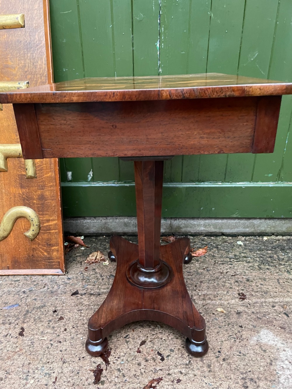 A nineteenth-century rectangular rosewood side table featuring a starburst specimen wood inlaid top set on a pedestal base with a quadform platform. View VIII