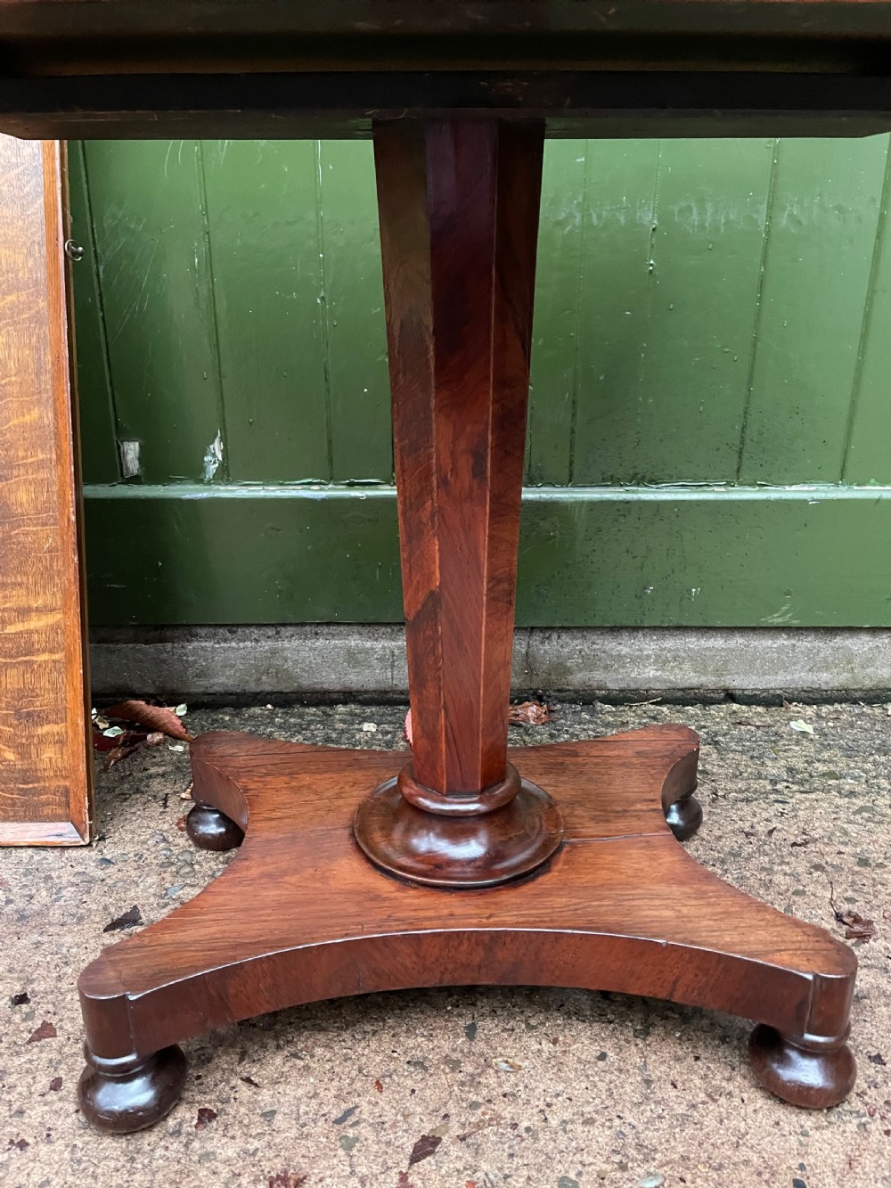 A nineteenth-century rectangular rosewood side table featuring a starburst specimen wood inlaid top set on a pedestal base with a quadform platform. View XIII