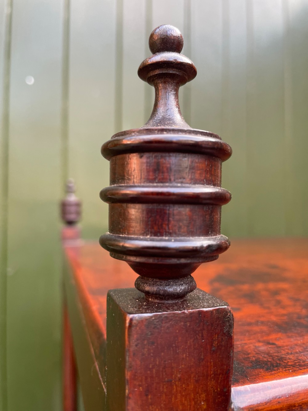 A tall late eighteenth-century George III mahogany etagere featuring open shelves, turned column supports, two drawers, and a lower enclosed cupboard. View XII