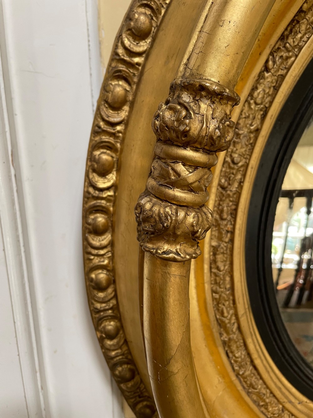 Large early C19th Regency period carved gilt-wood frame convex plate mirror  View III