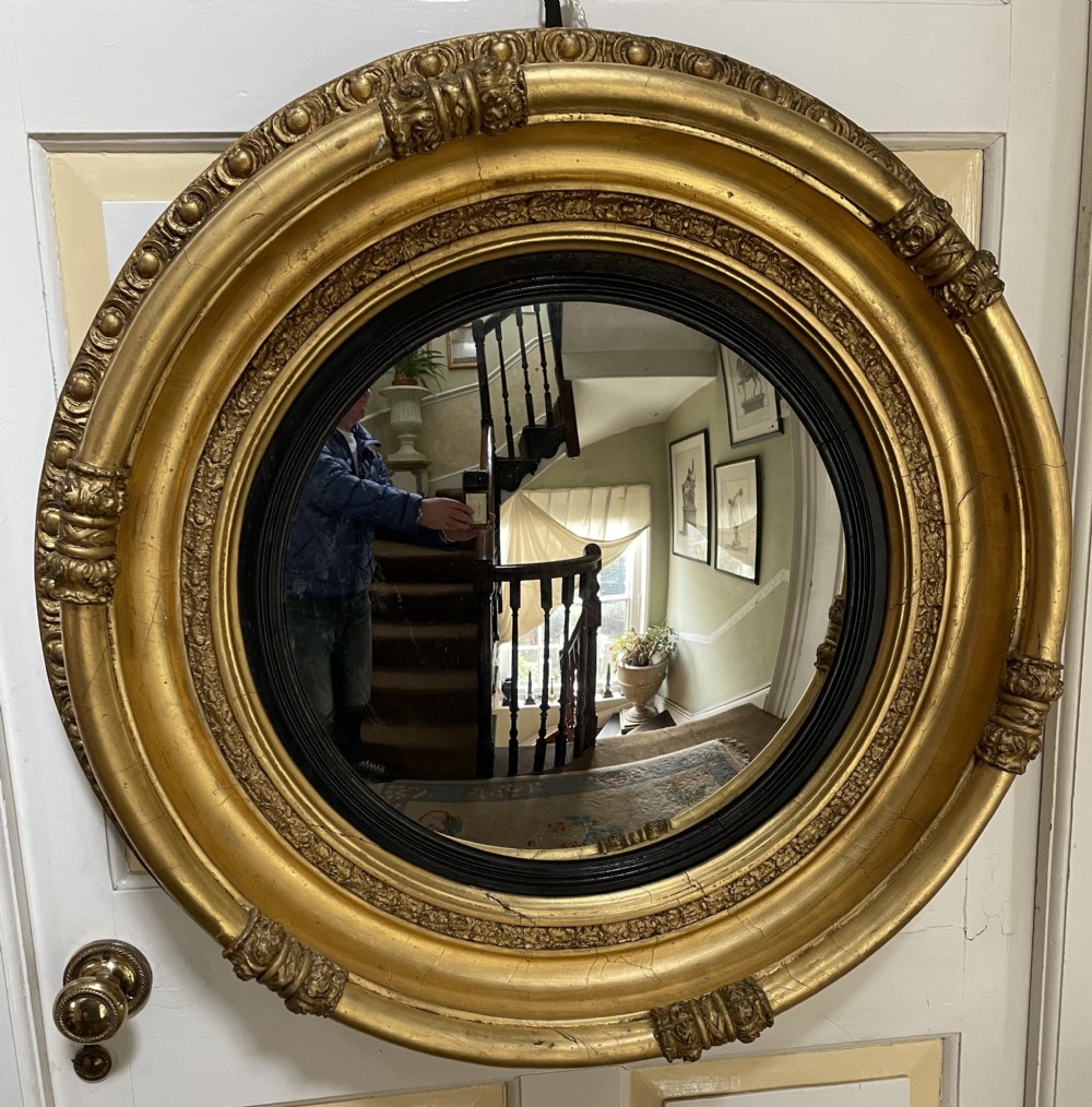 Large early C19th Regency period carved gilt-wood frame convex plate mirror 