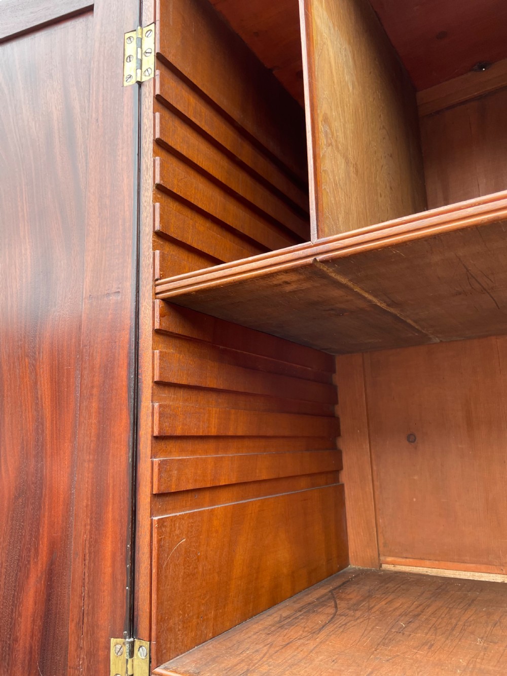 A late eighteenth-century George III mahogany estate cabinet featuring upper panel doors above drawers with gilded alphabetical lettering. View XXIII