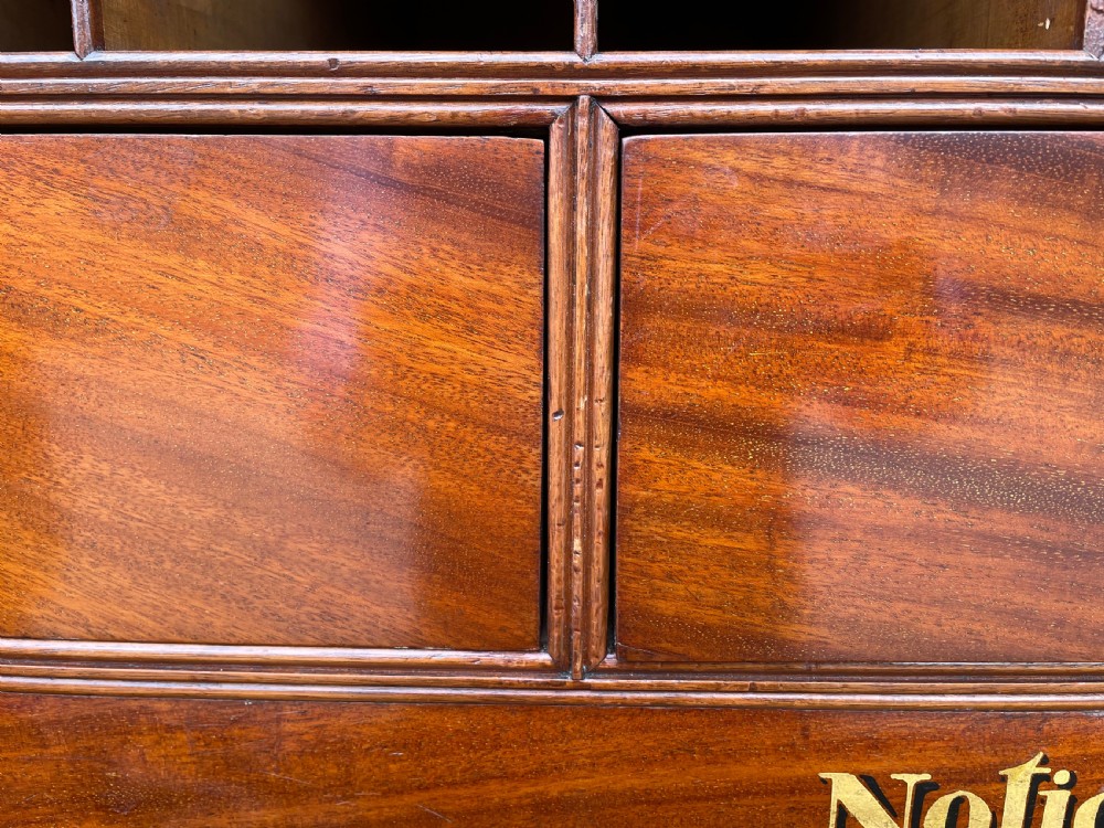 A late eighteenth-century George III mahogany estate cabinet featuring upper panel doors above drawers with gilded alphabetical lettering. View XXV