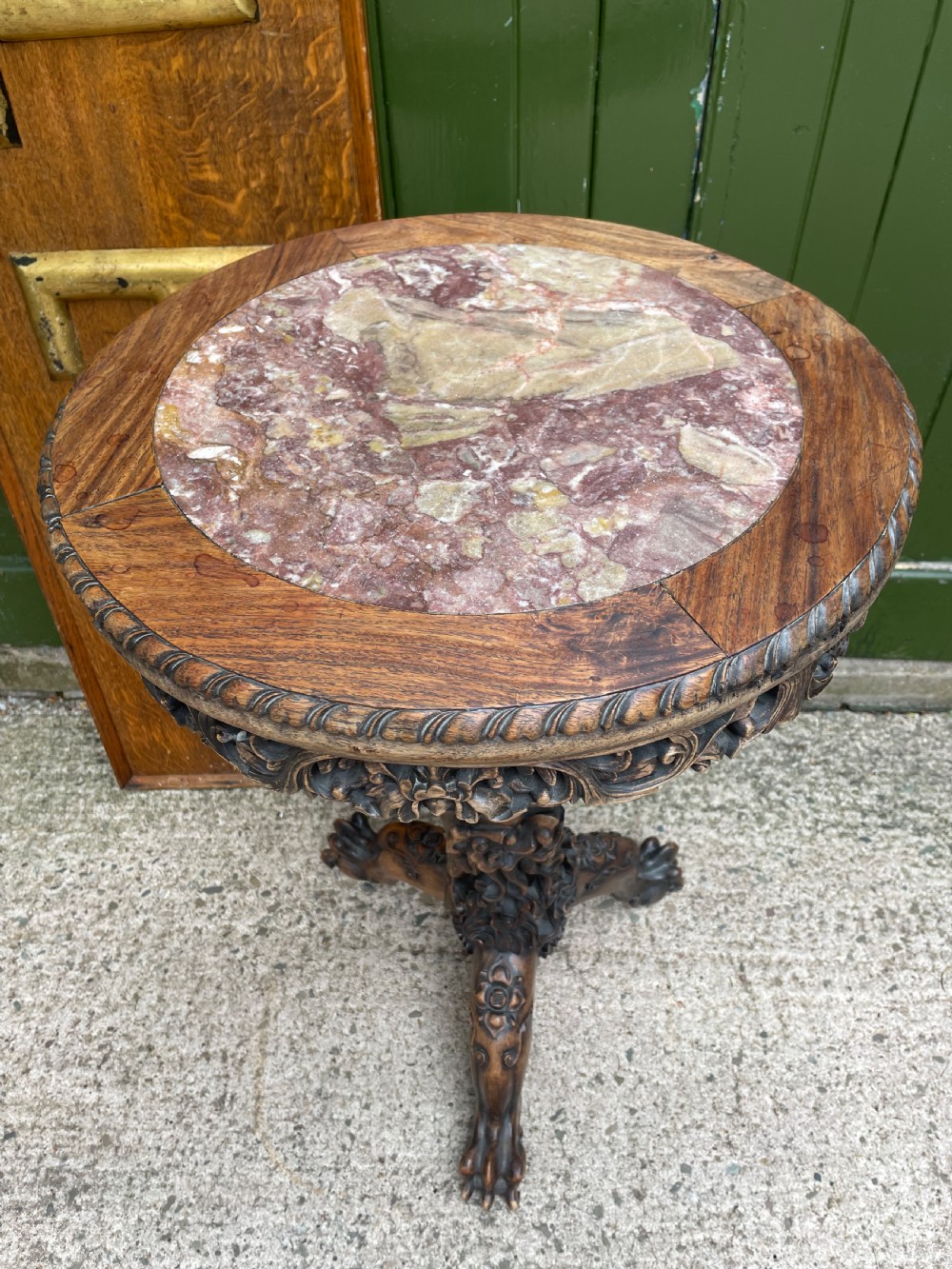 A late nineteenth-century Chinese dark hardwood occasional table featuring a round inset marble top, intricately carved dragon column, and a tripod base. View XI