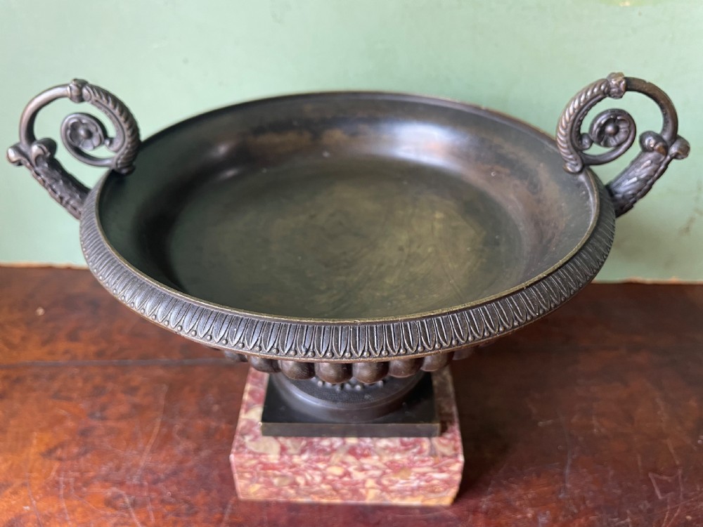 A pair of 19th-century dark bronze tazzas featuring gadrooned bowls and scroll handles, each mounted on a square red mottled marble base. View XI