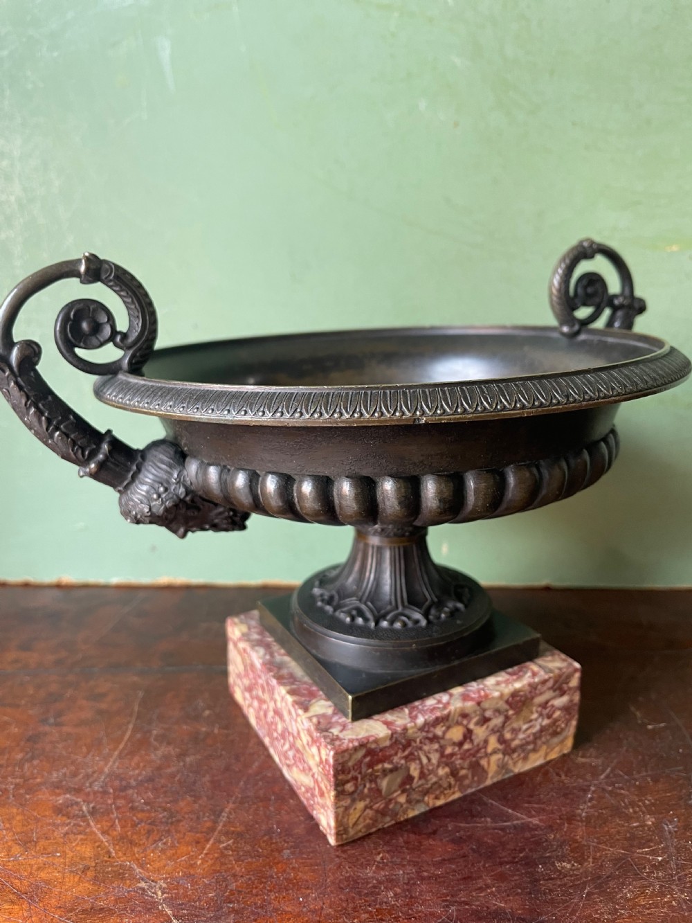 A pair of 19th-century dark bronze tazzas featuring gadrooned bowls and scroll handles, each mounted on a square red mottled marble base. View XIII