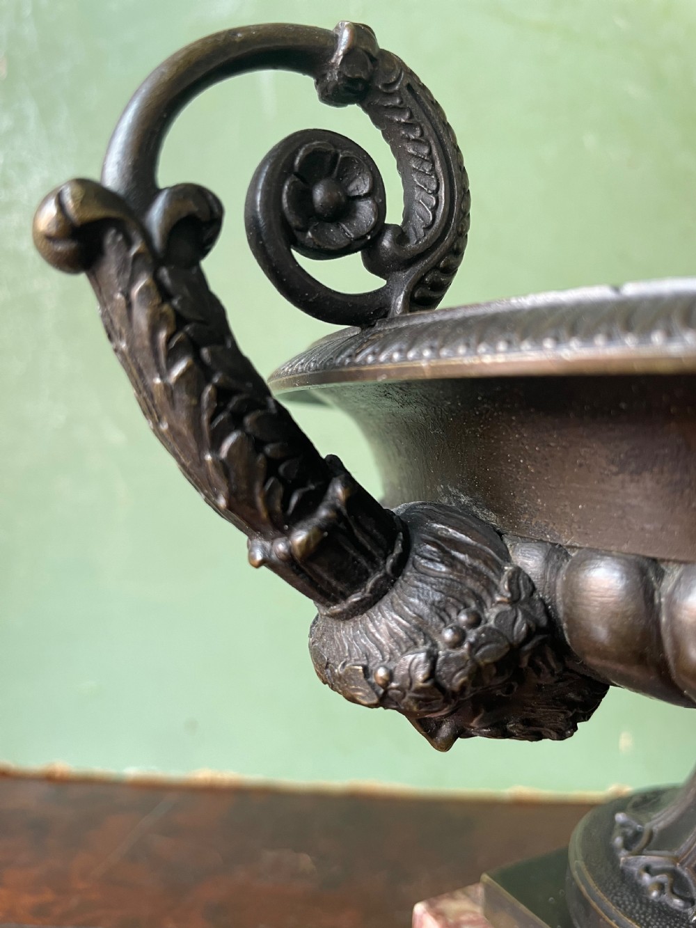 A pair of 19th-century dark bronze tazzas featuring gadrooned bowls and scroll handles, each mounted on a square red mottled marble base. View XV