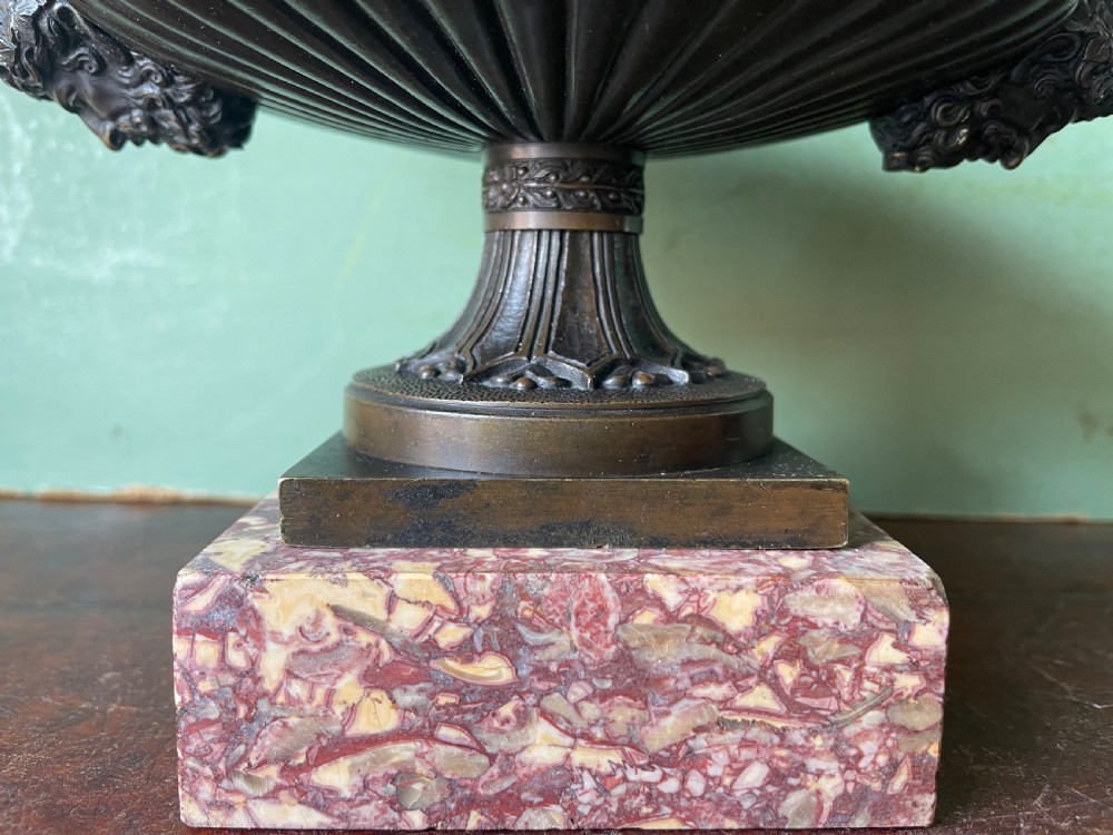A pair of 19th-century dark bronze tazzas featuring gadrooned bowls and scroll handles, each mounted on a square red mottled marble base. View XXVII