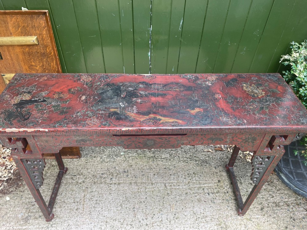 A late nineteenth-century Chinese red lacquered altar table featuring carved decorative spandrels and a patinated surface. View III