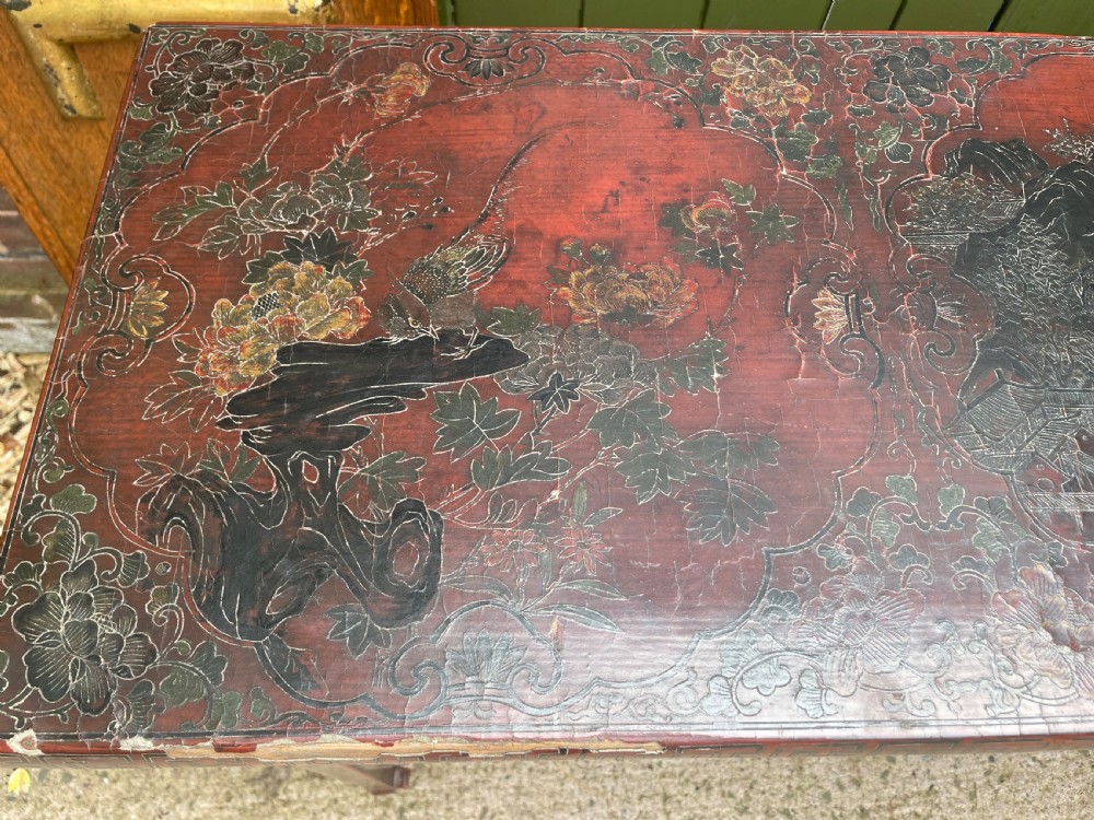 A late nineteenth-century Chinese red lacquered altar table featuring carved decorative spandrels and a patinated surface. View VII