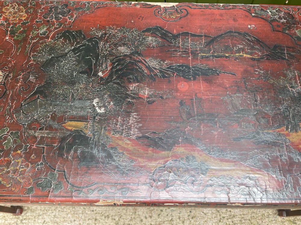 A late nineteenth-century Chinese red lacquered altar table featuring carved decorative spandrels and a patinated surface. View VIII