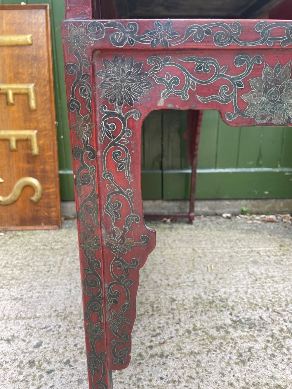 A late nineteenth-century Chinese red lacquered altar table featuring carved decorative spandrels and a patinated surface. View XI