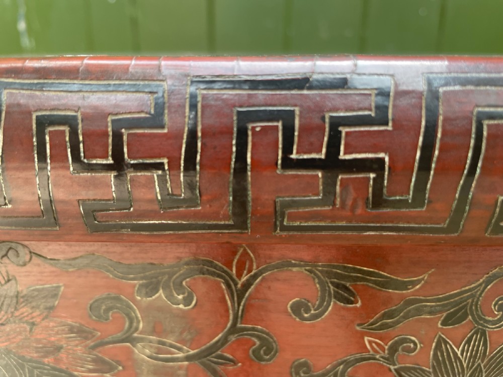 A late nineteenth-century Chinese red lacquered altar table featuring carved decorative spandrels and a patinated surface. View XX