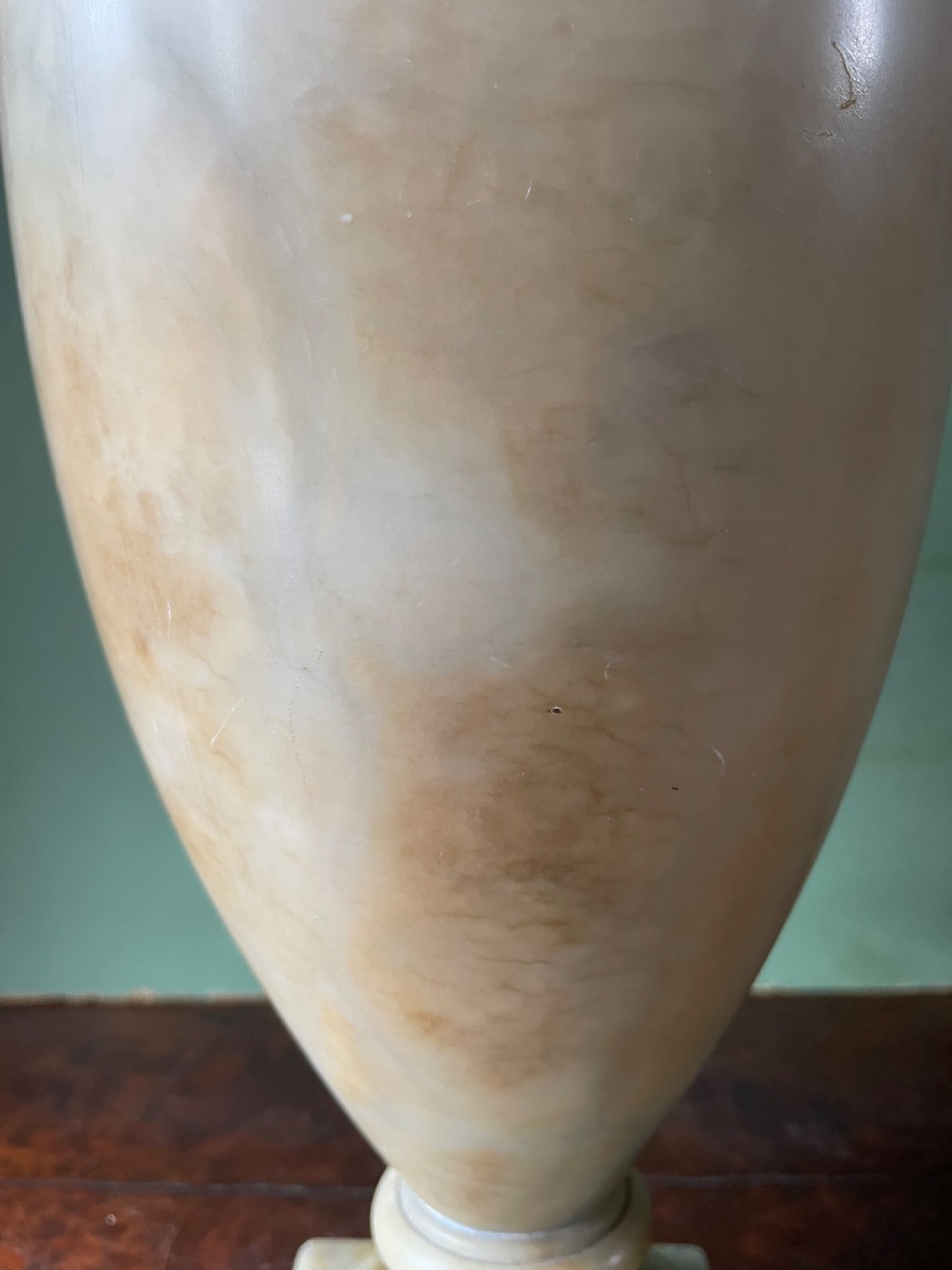 A pair of early nineteenth-century carved cream alabaster classical urns with lids, angular side handles, and square pedestal bases. View X