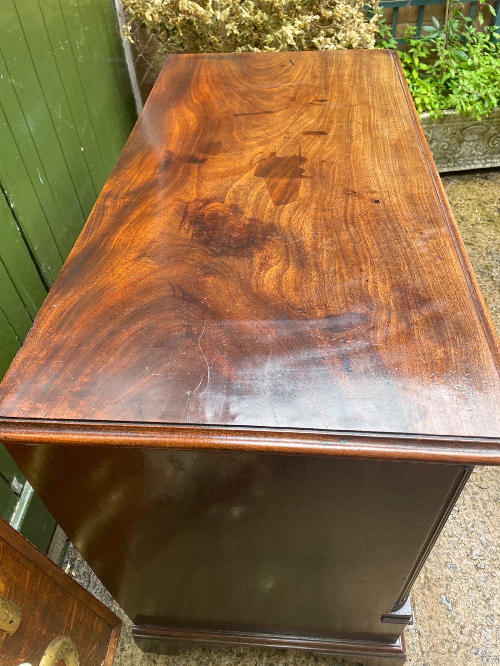 A mid-18th century George III mahogany chest of drawers featuring a two over three drawer layout with brass handles and bracket feet. View VI