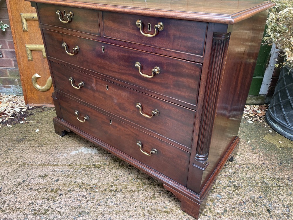 A mid-18th century George III mahogany chest of drawers featuring a two over three drawer layout with brass handles and bracket feet. View VIII