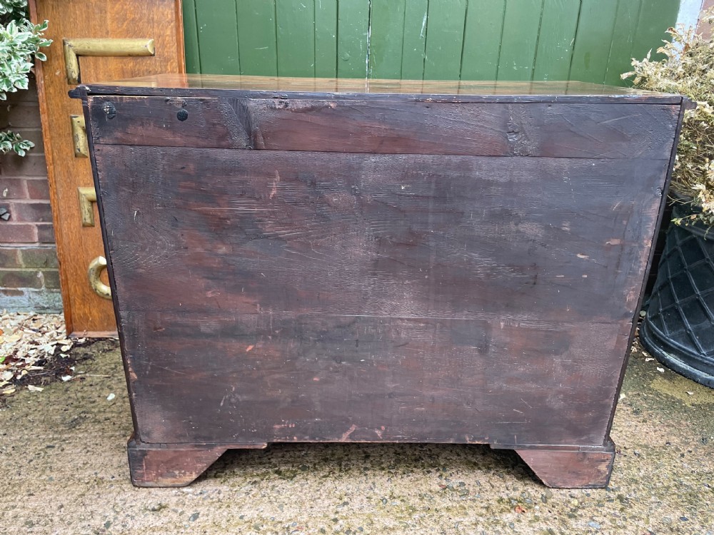 A mid-18th century George III mahogany chest of drawers featuring a two over three drawer layout with brass handles and bracket feet. View XV