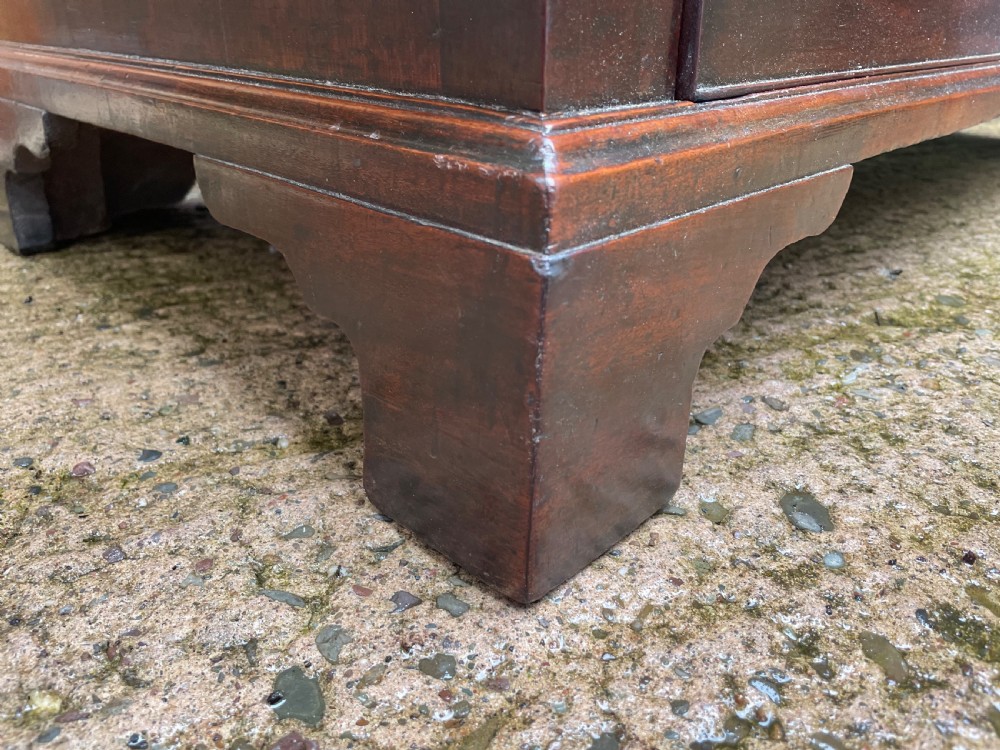 A mid-18th century George III mahogany chest of drawers featuring a two over three drawer layout with brass handles and bracket feet. View XVI