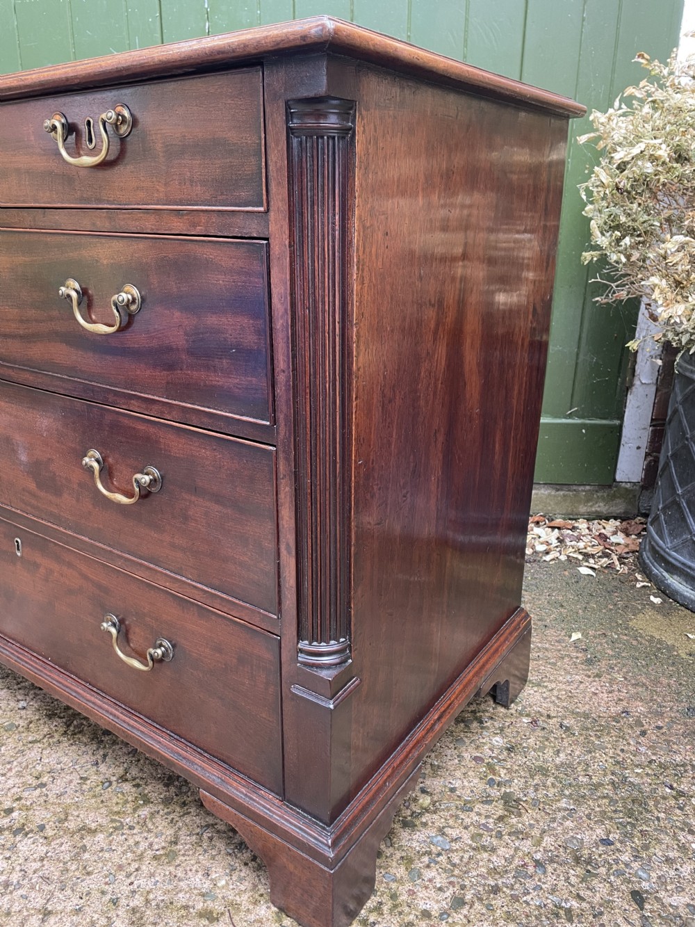 A mid-18th century George III mahogany chest of drawers featuring a two over three drawer layout with brass handles and bracket feet. View XVII