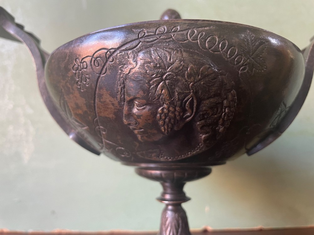 A nineteenth-century bronze lidded tazza featuring Greek key chasing and elevated handles, supported by a round red marble base. View X