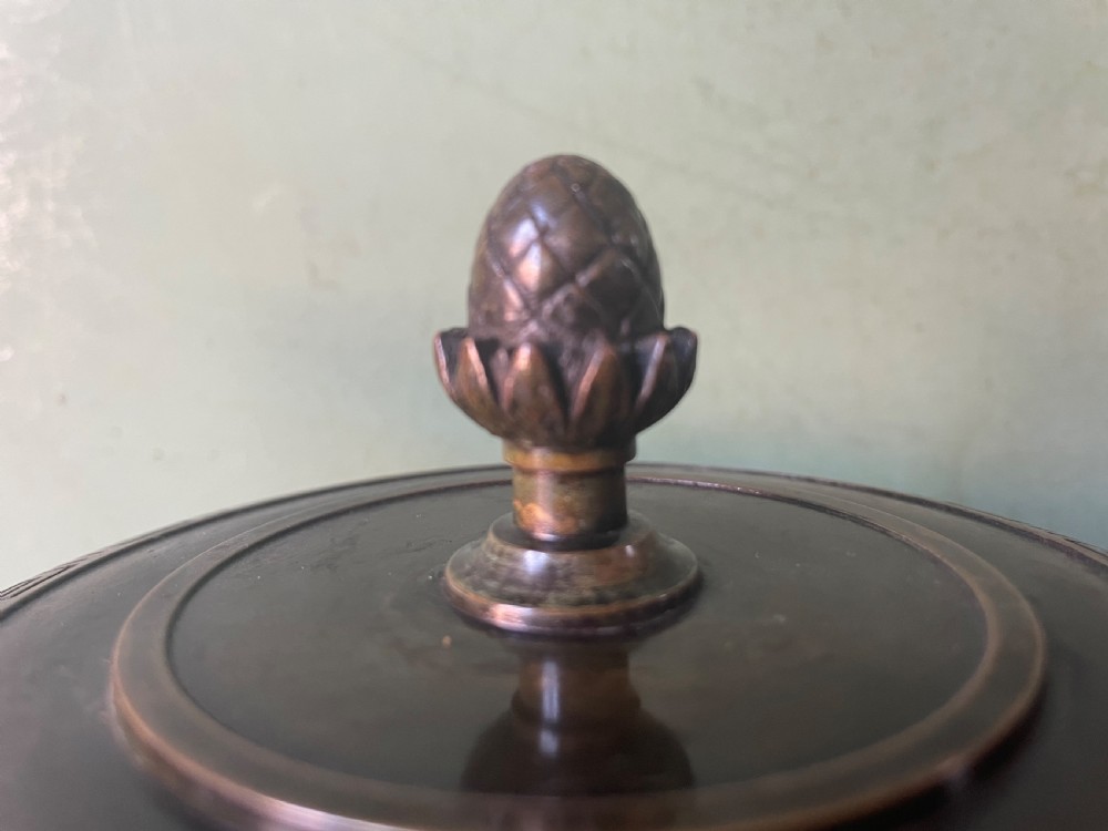 A nineteenth-century bronze lidded tazza featuring Greek key chasing and elevated handles, supported by a round red marble base. View XV