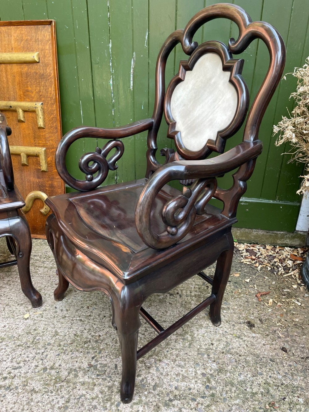 A pair of late Qing Dynasty dark hardwood armchairs with circular marble splat inlays flanking a matching two-tier stand. View IX