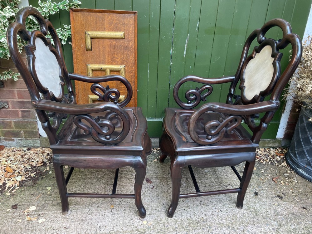 A pair of late Qing Dynasty dark hardwood armchairs with circular marble splat inlays flanking a matching two-tier stand. View XIV