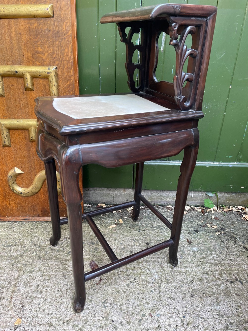 A pair of late Qing Dynasty dark hardwood armchairs with circular marble splat inlays flanking a matching two-tier stand. View XV