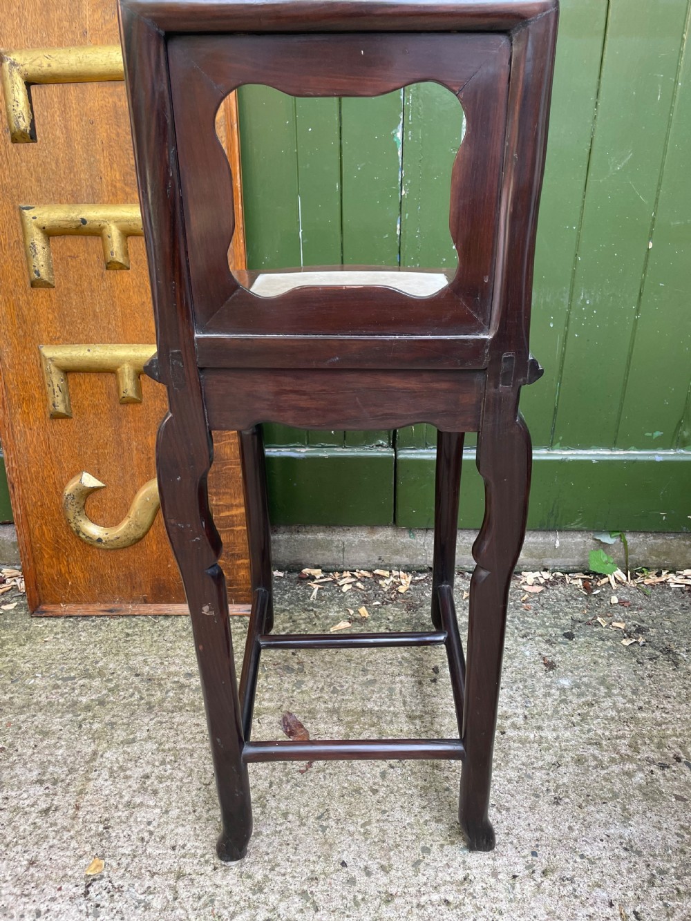 A pair of late Qing Dynasty dark hardwood armchairs with circular marble splat inlays flanking a matching two-tier stand. View XVI