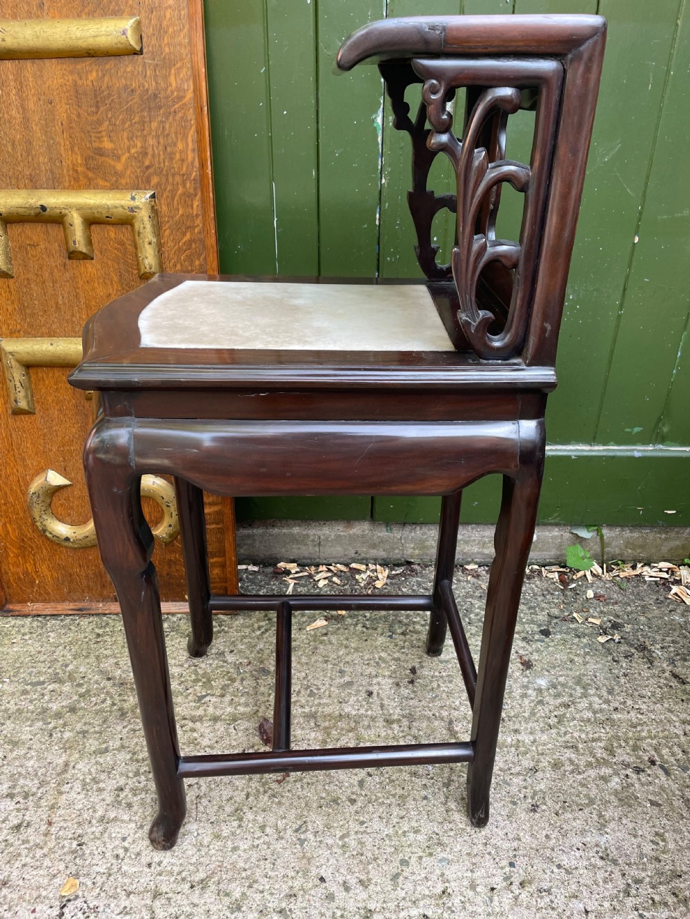 A pair of late Qing Dynasty dark hardwood armchairs with circular marble splat inlays flanking a matching two-tier stand. View XVIII