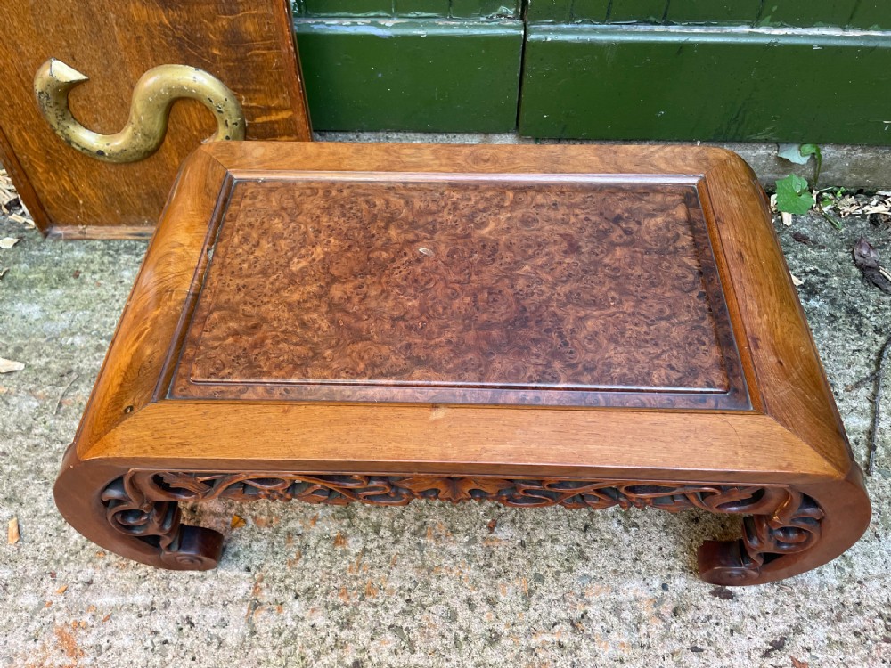 A low carved dark hardwood Chinese Kang table featuring scroll feet and a pierced floral apron. View III