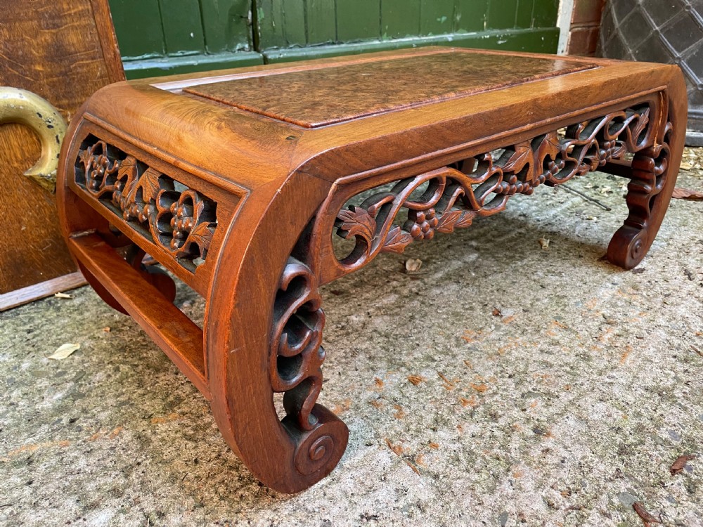 A low carved dark hardwood Chinese Kang table featuring scroll feet and a pierced floral apron. View IV