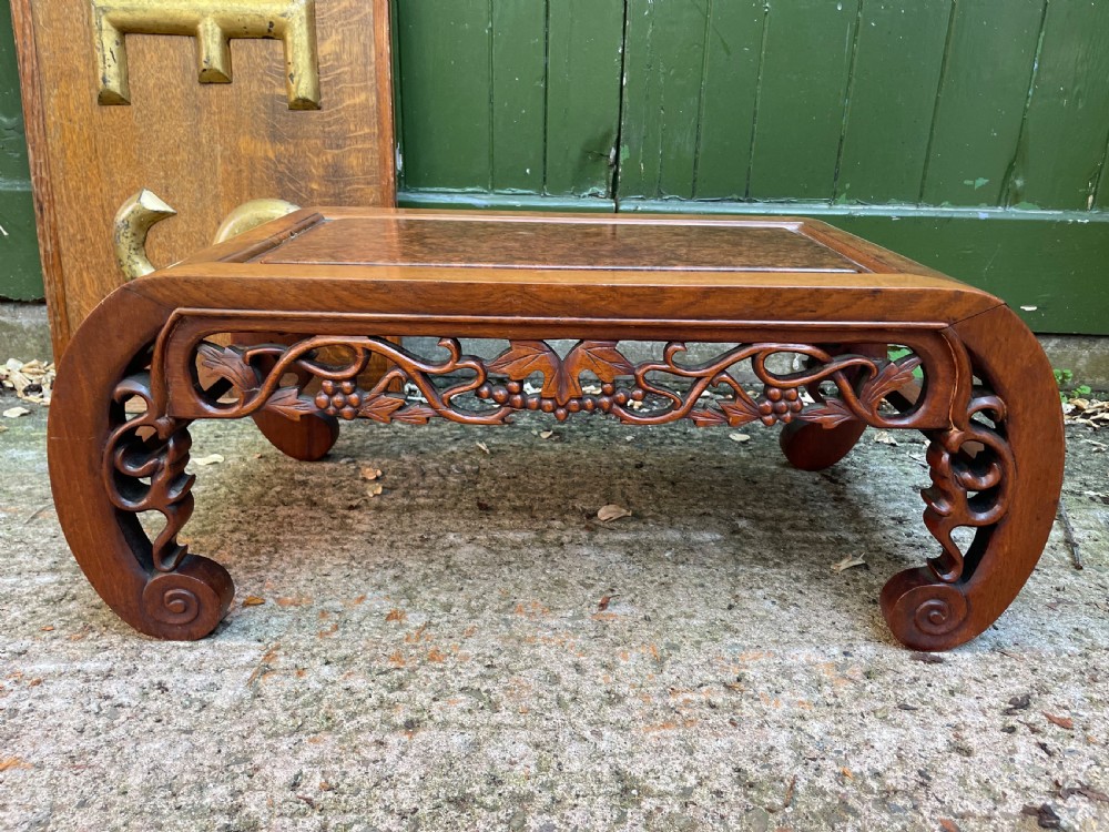 A low carved dark hardwood Chinese Kang table featuring scroll feet and a pierced floral apron. View VI